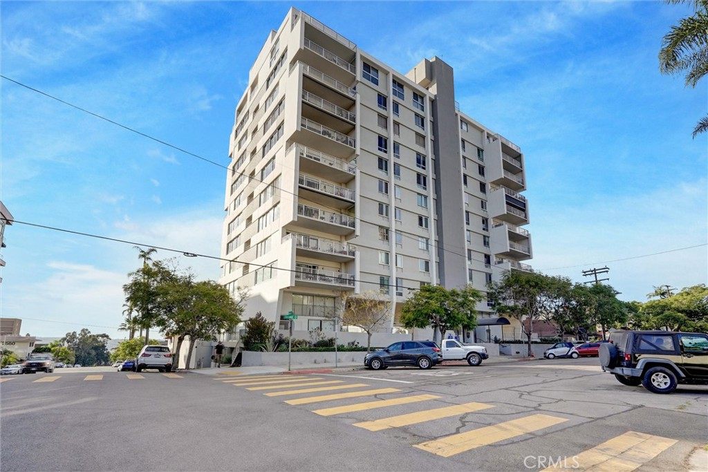 A ten-story condo building in Bankers Hill, San Diego, with stacked balconies, seen from the street corner