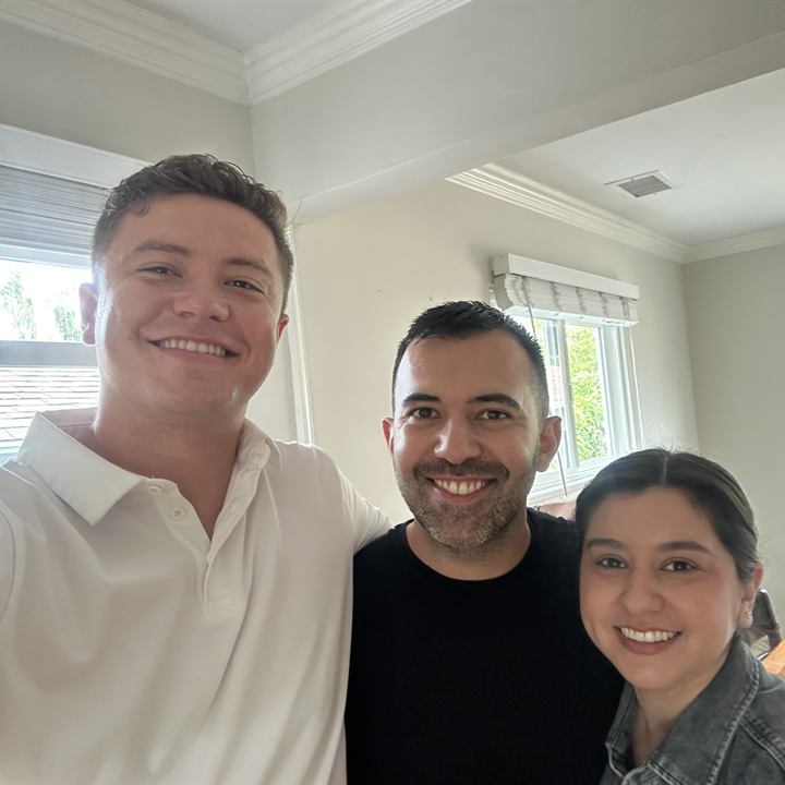 Jared Harman with two clients inside a home