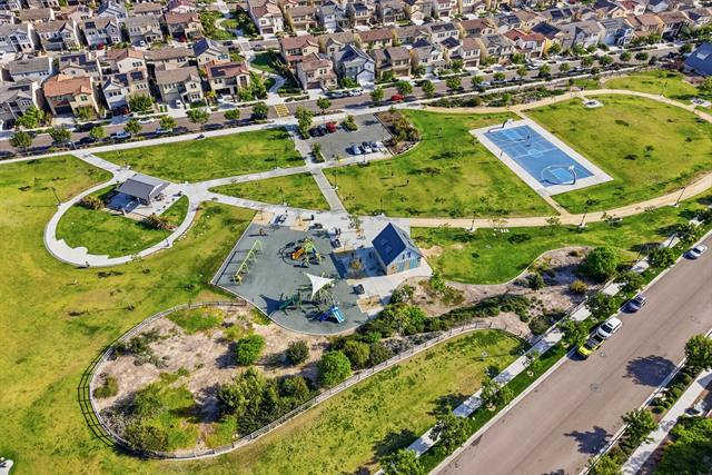 Aerial view of a neighborhood park with walking paths and a pool