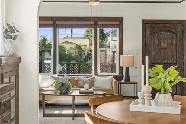 Sitting room with wood-framed windows, a sofa and a round table